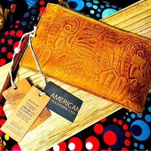 Tooled wristlet with charging capability
